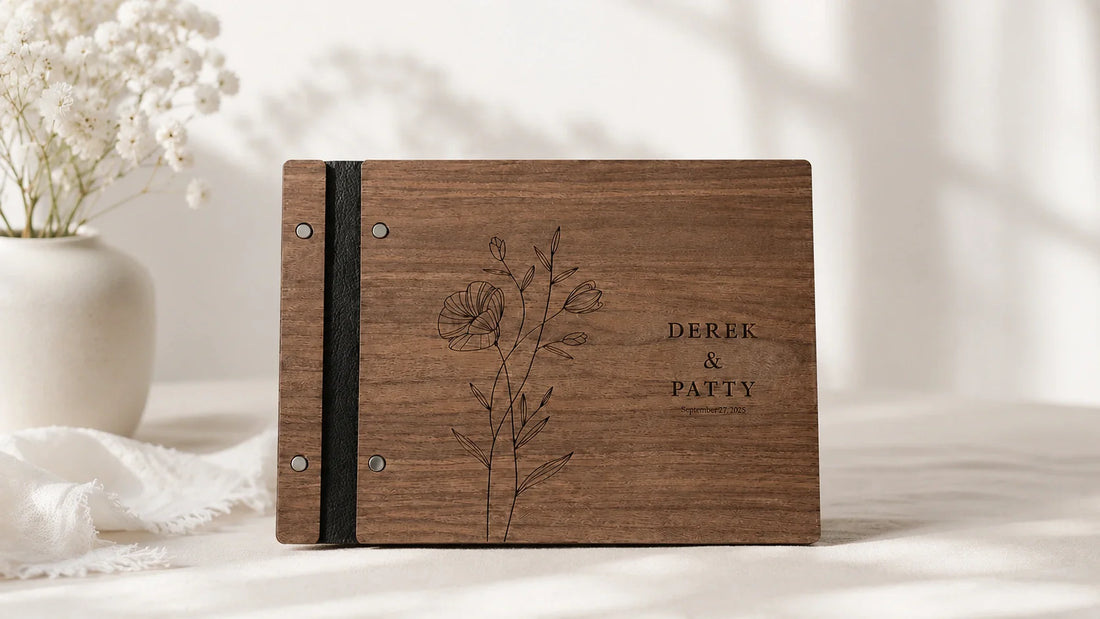 Personalized wooden rustic wedding guest book displayed with dried florals and instant photos at a countryside wedding reception.